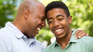 A teenager and guardian smiling