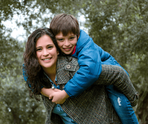 Young boy and adult women hugging