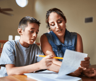 boy doing homework with foster mom