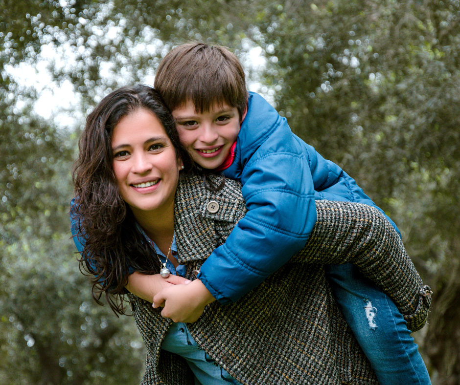 young boy and adult women family member hugging